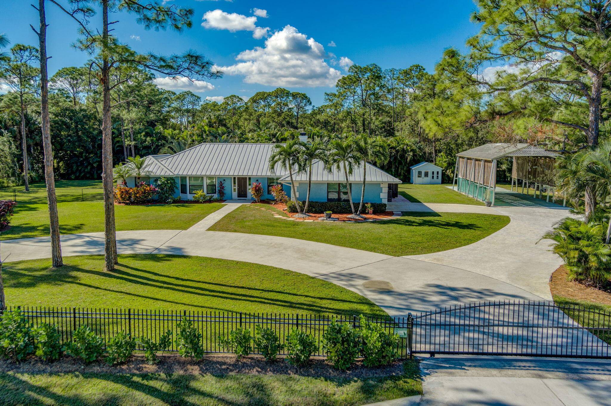Amazing one of a kind oasis in Palm Beach Country Estates, enter through one of two new private sliding gates onto your 18 foot wide circular driveway, huge 20' x ...