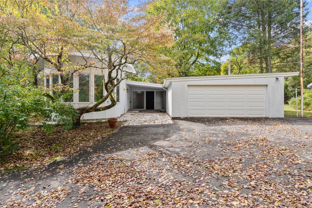 Step into this one of a kind mid century ranch, nestled in the heart of Monroe.