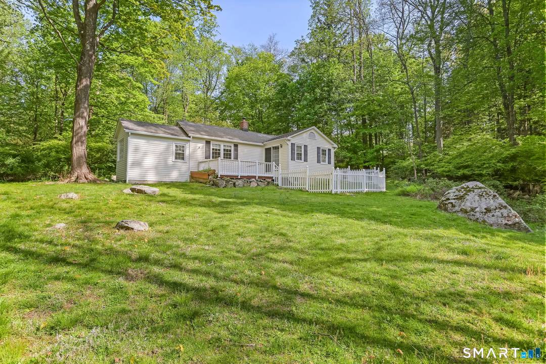Tucked away on a very special private road, 4 Topping Lane offers a rare sense of privacy and charm in Norwalk.