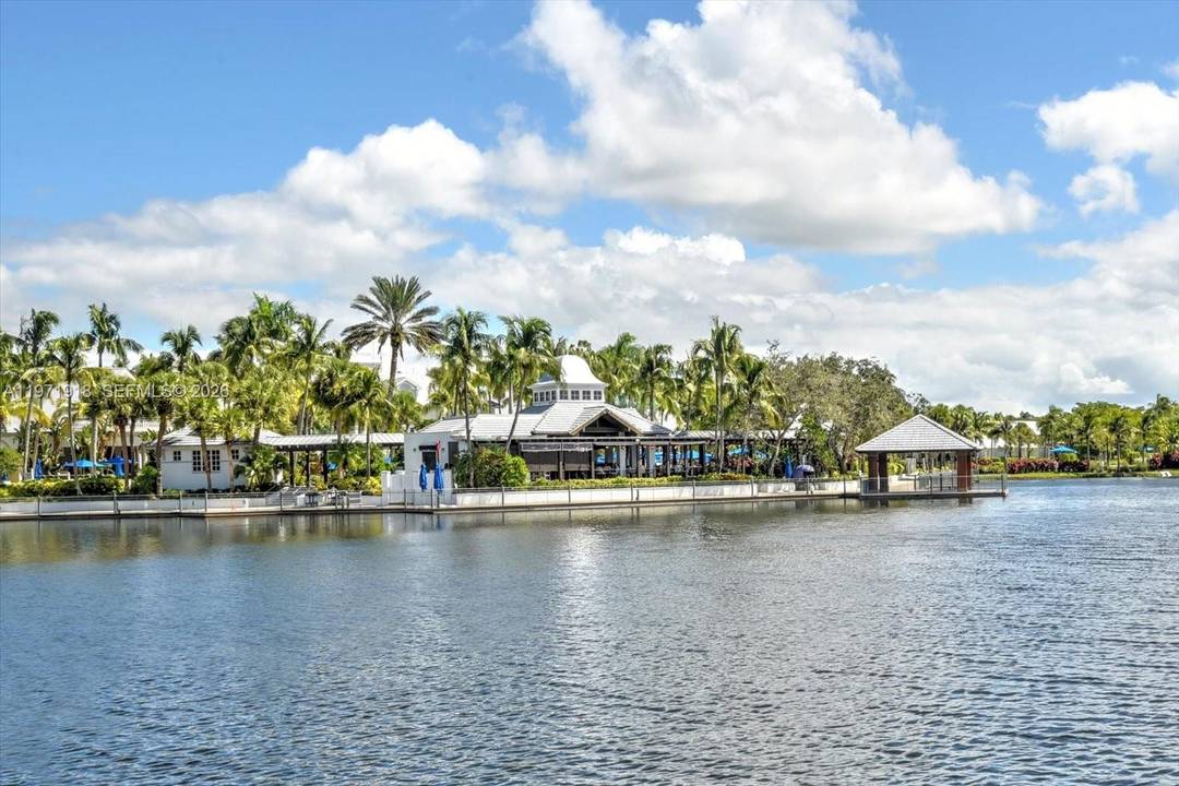 SELLER TO OFFER A REBATE ON CLUB MEMBERSHIP FEE to the BUYER on this Beautiful, Corner Unit on Serene Pond with Screened Lanai and attached one car garage.