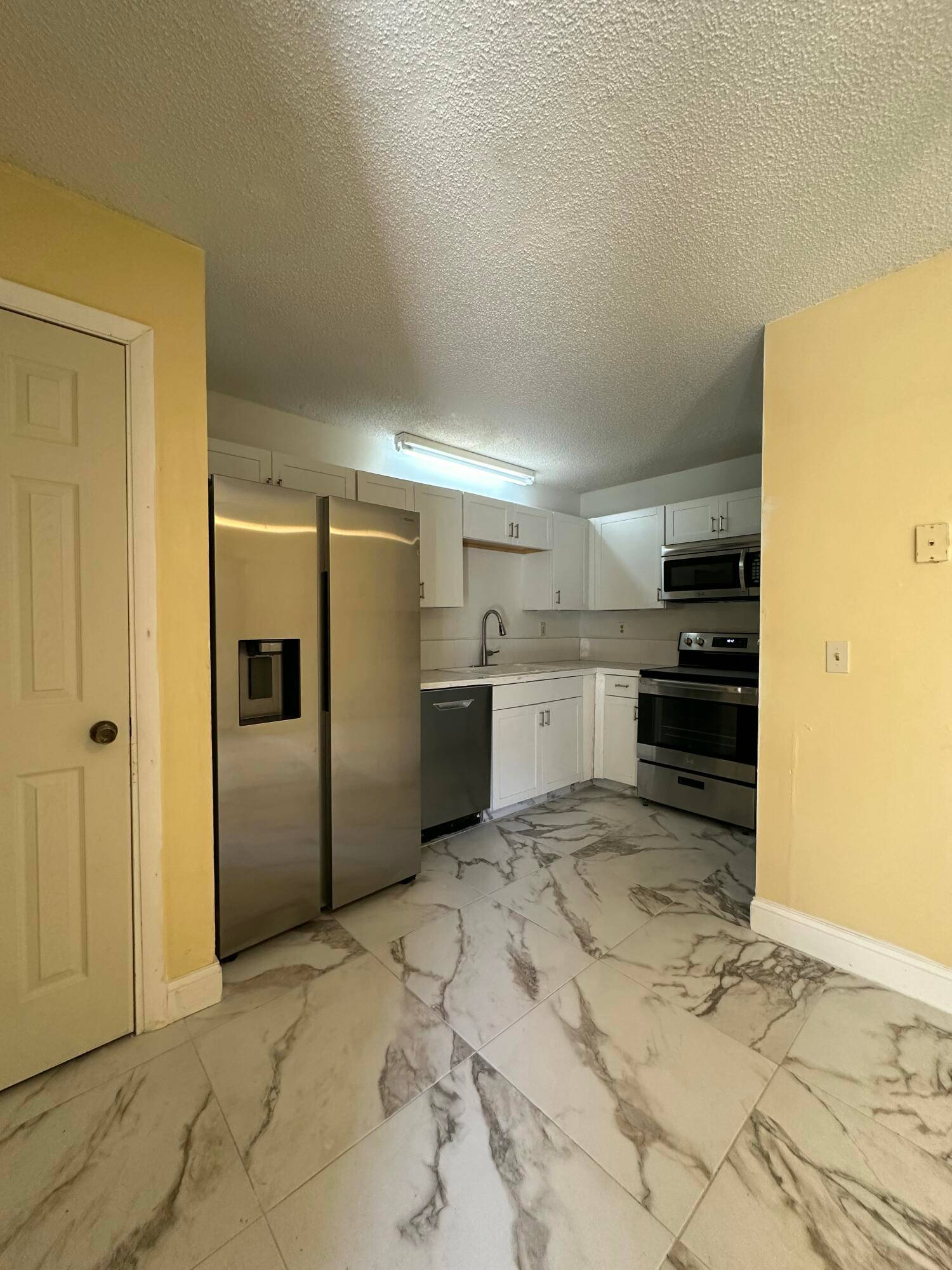 This spacious townhouse features a convenient ground floor bedroom and full bath, perfect for guests or flexible living.