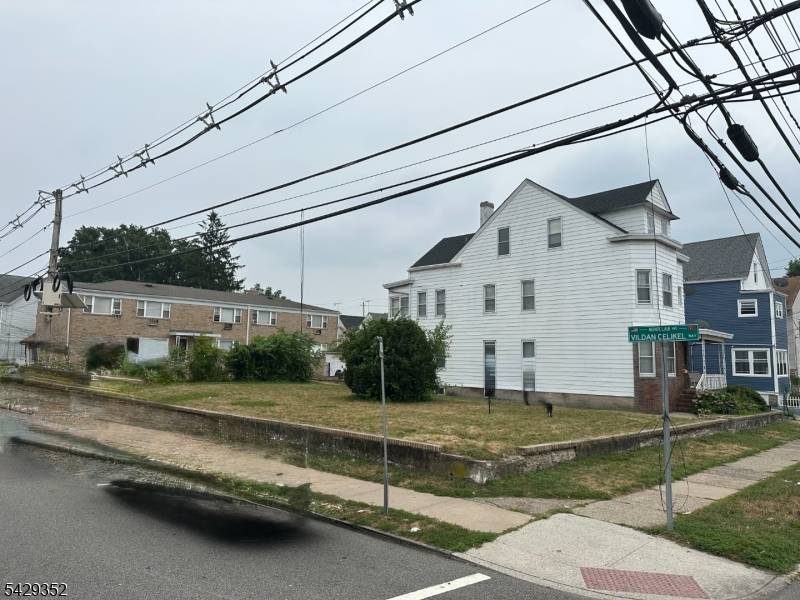 One of a Kind 2 family with large vacant corner lot in South Paterson Clifton Border.