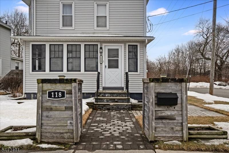 Step inside this inviting colonial style home through the enclosed front porch.