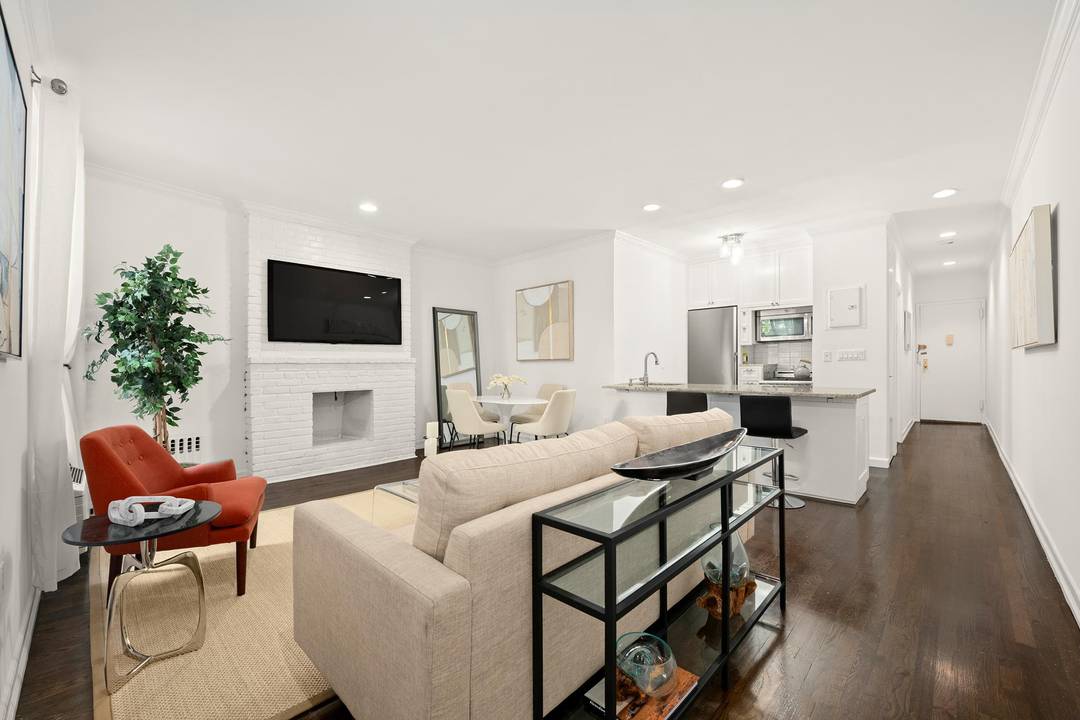 Step into this stunning two bedroom condominium, a perfect blend of modern luxury and urban charm, just a block away from Central Park.