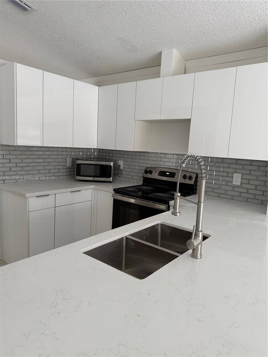 Spacious single family home in a quiet gated community near FIU, schools, highways, and shopping.
