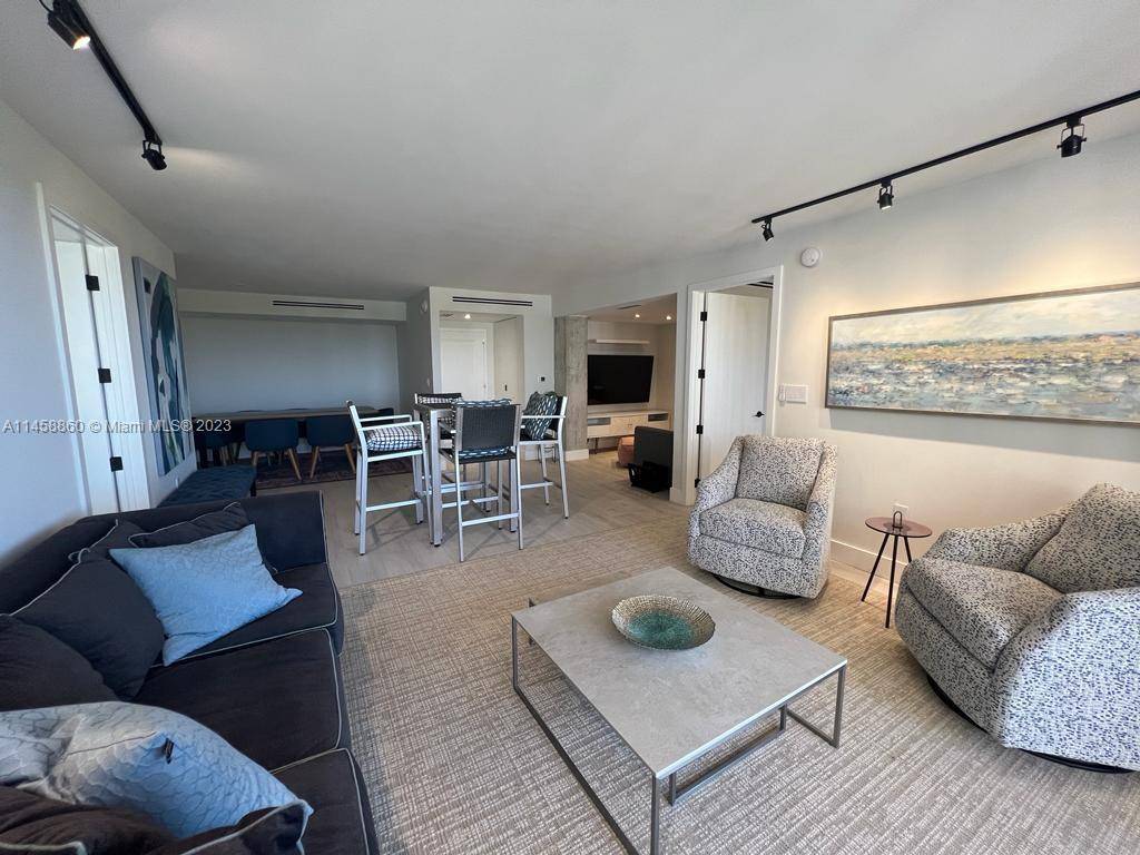 Beautifully renovated 2 2 plus den in the Towers of Key Biscayne is decorated in muted tones of white grey beige.