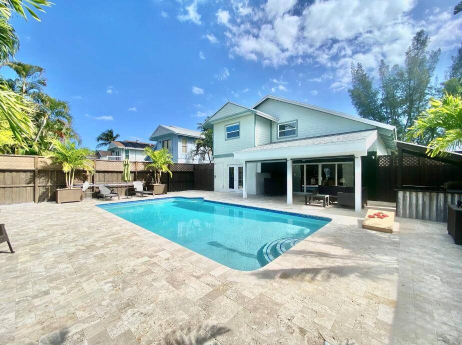 Beautifully updated, light filled home in East Delray featuring a private saltwater pool and fully fenced backyard.