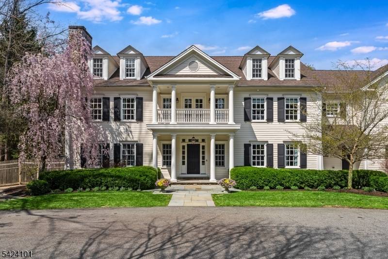 This Georgian colonial home is set on over three acres on one of Mendham's most desirable streets.