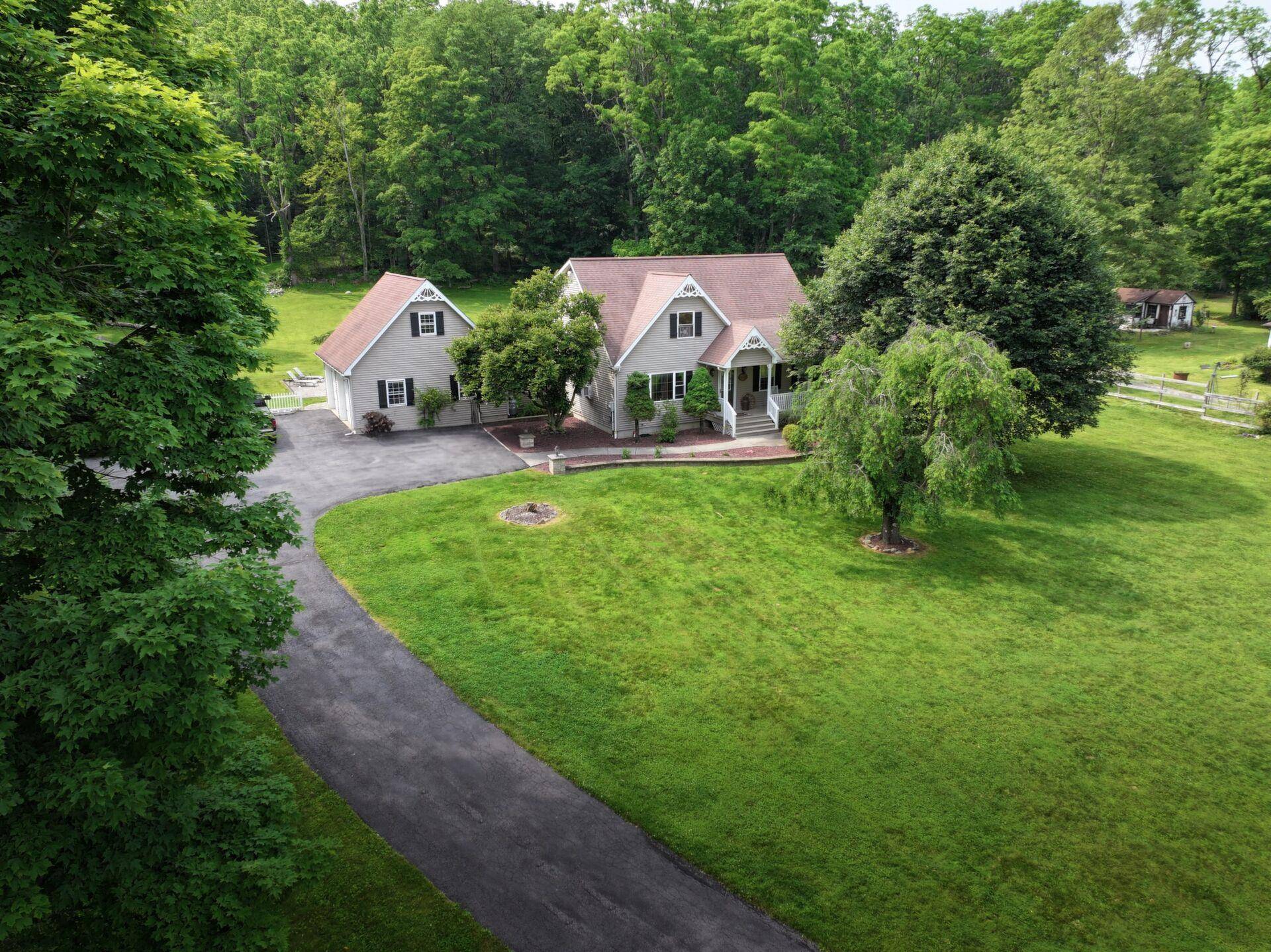 Cape Cod style home nestled on a spacious 2 acre lot, offering the perfect combination of space, comfort, and character.