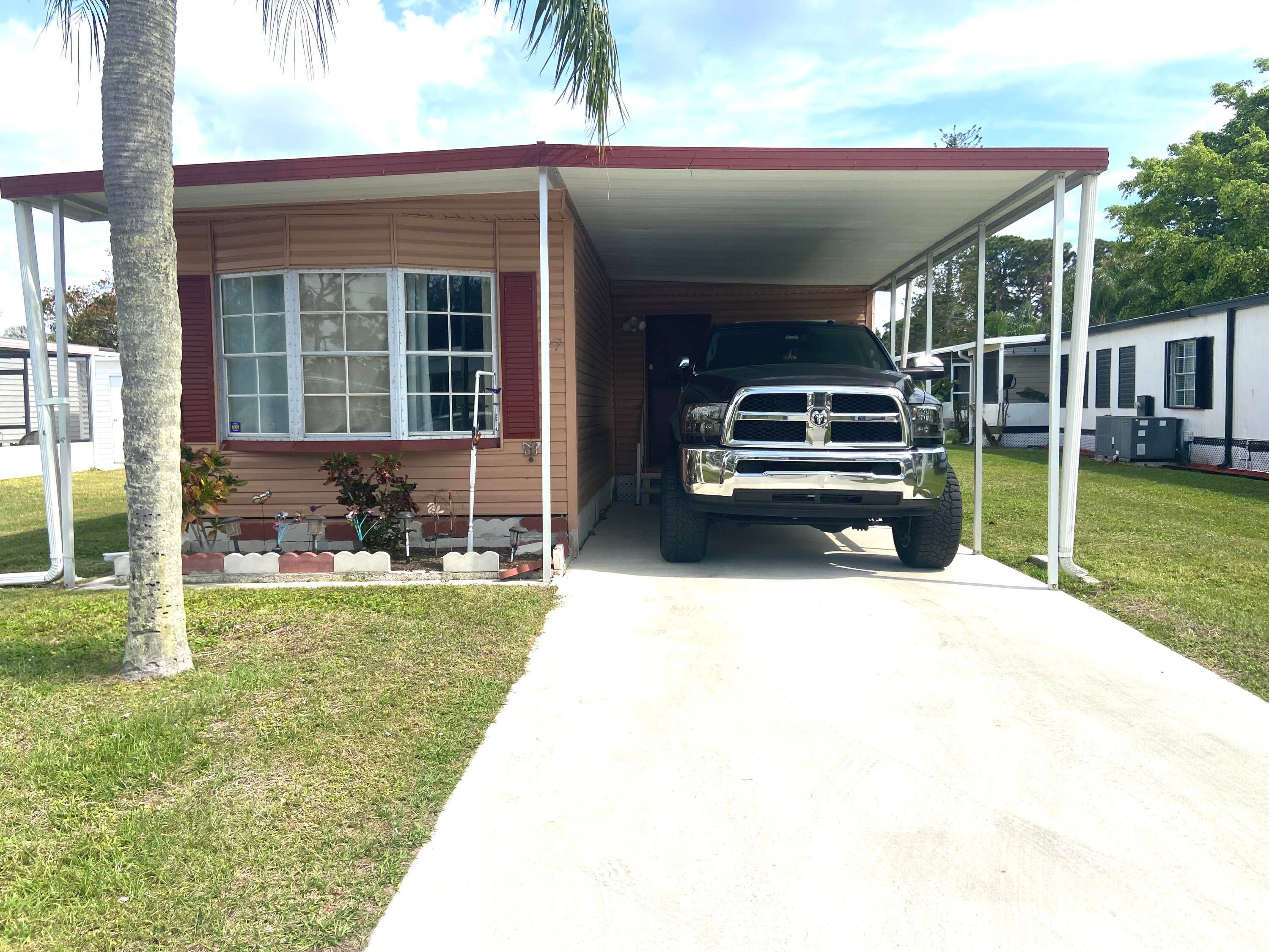 REDUCED This 2 bed 2 bath home with laminate flooring and drywall ceilings boasts lots of living space and a large SCREENED room for on demand enjoyment !