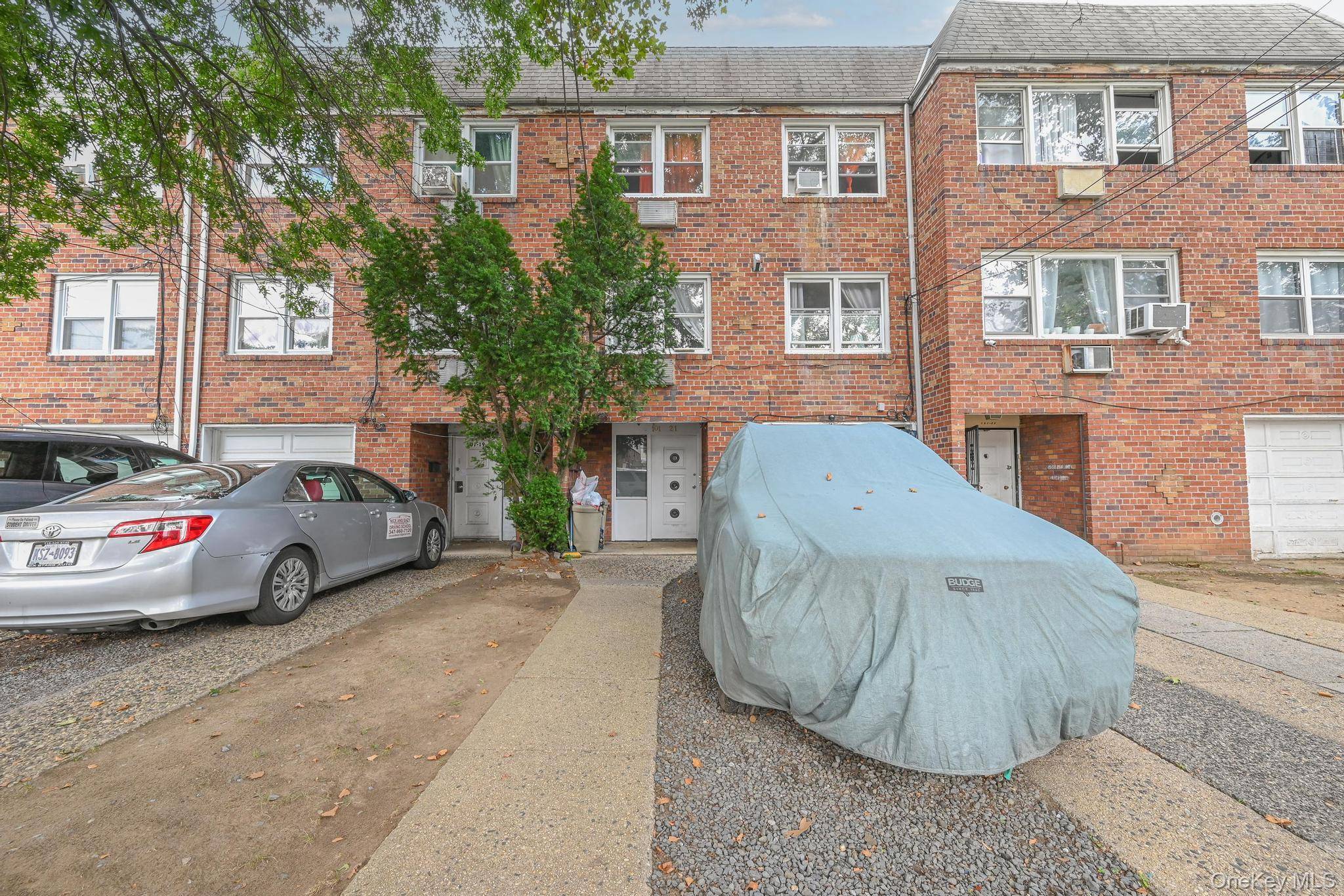 Well kept two family brick house, with full finished above ground walk in basement, private driveway and garage in heart of Queens.