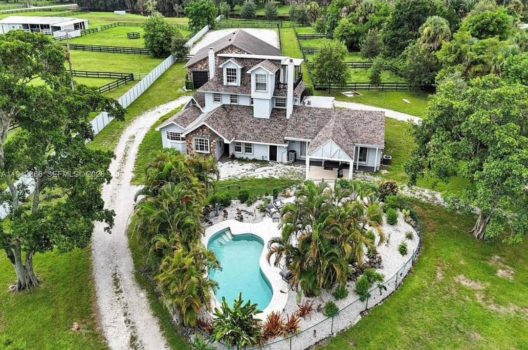 Expansive estate property situated on over two acres of land, offering privacy, space, and versatility.