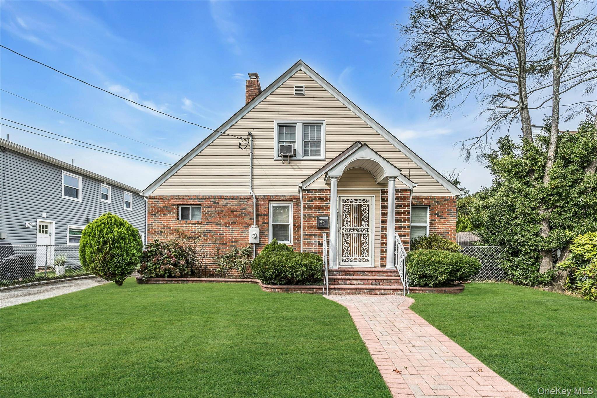 A Charming In line Brick Cape Cod featuring Main Floor Primary Bedroom with a Ductless Air System, 2 1 2 Bathrooms, Eat in Kitchen, True Formal Dining, Large Living room ...