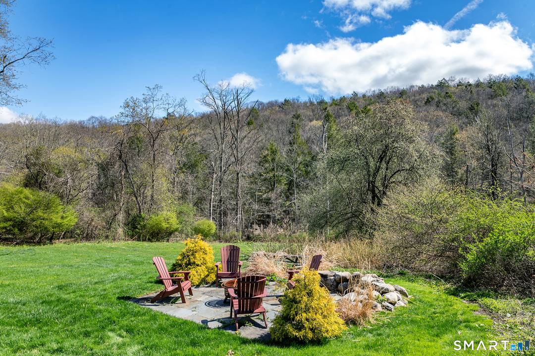 Experience riverside serenity in this masterfully updated country retreat overlooking the Shepaug River.