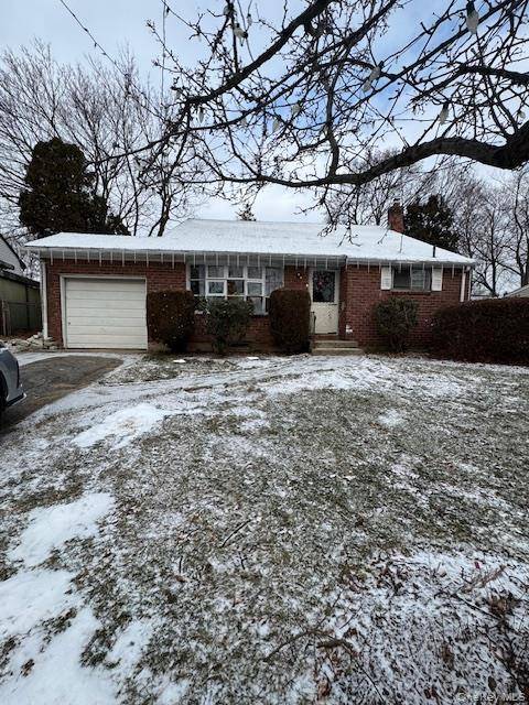 Three bedroom two full bath split level home offering hardwood floors, attached garage, and a nice yard.