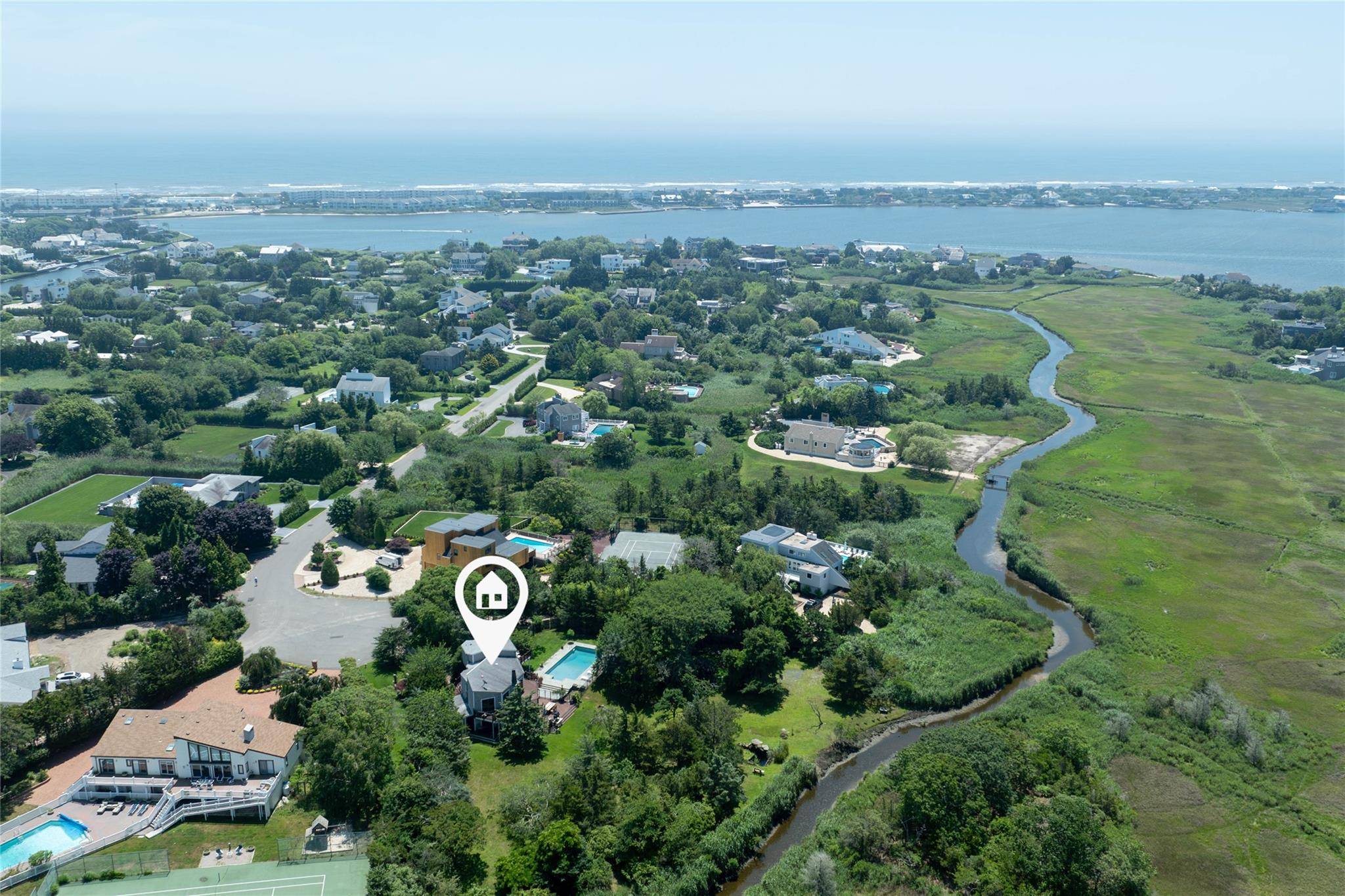 Nestled at the end of a quiet cul de sac with direct water access, this contemporary shingle style home offers privacy, natural beauty, and seamless indoor outdoor living.