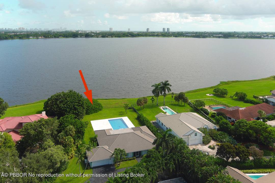 BoHo Chic, open concept living in this re imagined 4bed, 4bath masterpiece, nestled on a sprawling over half acre lot with stunning Lake Mangonia views.