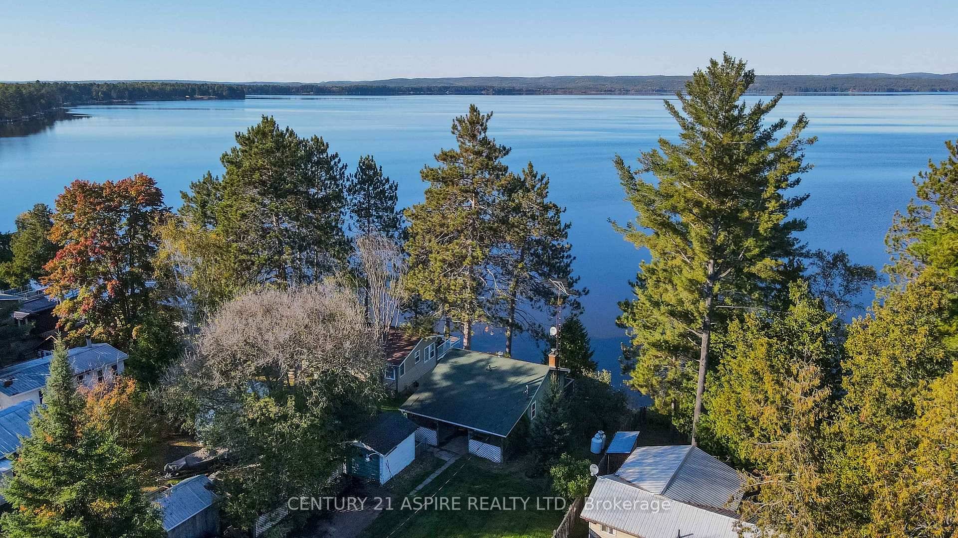 Welcome to 751 Rock Point Lane, a charming waterfront retreat nestled on the serene shores of the highly sought after Round Lake.