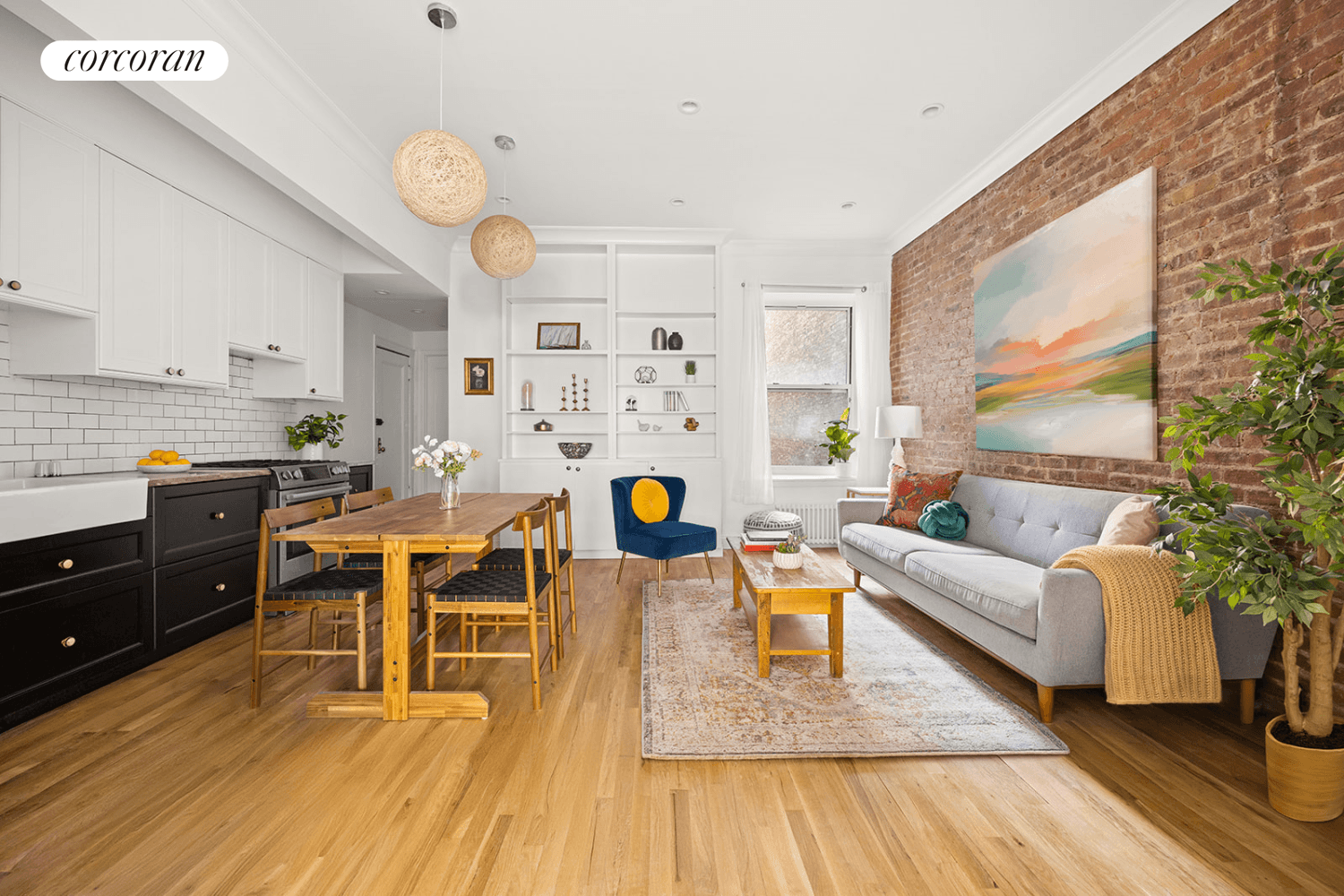 This beautifully renovated pre war co op features a living room distinguished by an exposed brick wall that adds warmth and texture to the open space, complemented by high ceilings ...