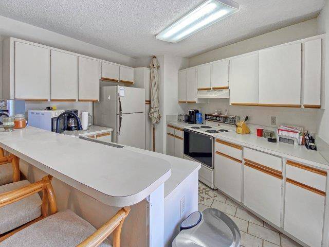 Step inside this inviting fully furnished townhome featuring an open concept layout where a stylish kitchen flows seamlessly into a spacious living area perfect for everyday living and entertaining.