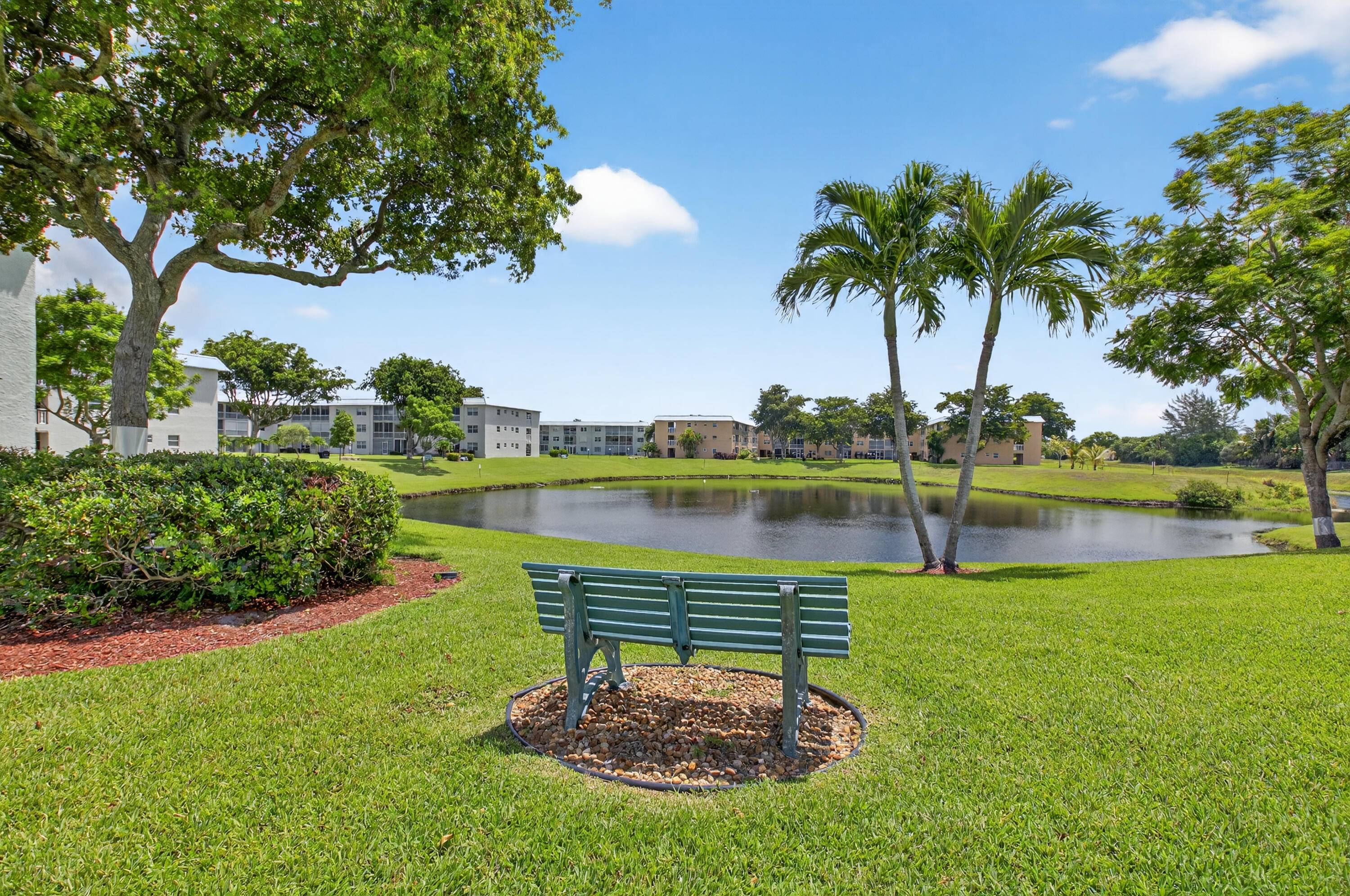 Seller offers Owner Financing for this magnificently remodeled 2 bedroom, 2 bath first floor unit overlooking the lake and garden beyond.