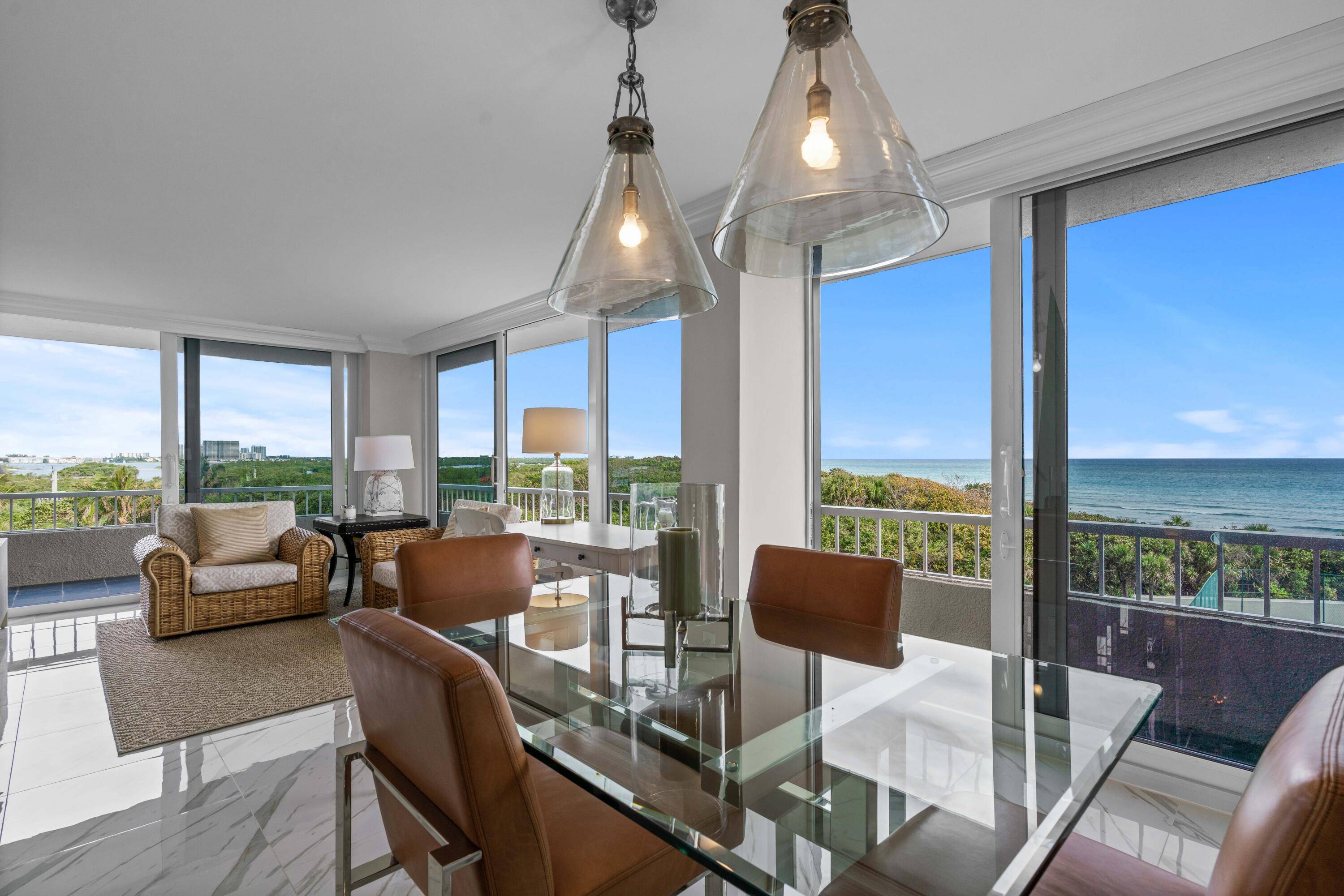 Welcome to your waterfront home at Water Glades on Singer Island, where direct ocean views await just beyond the sliding glass doors.