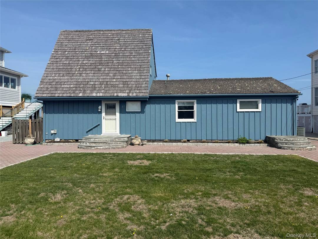 Embrace refined coastal living in this stunning modern style waterfront rental overlooking the tranquil waters of Shinnecock Bay.