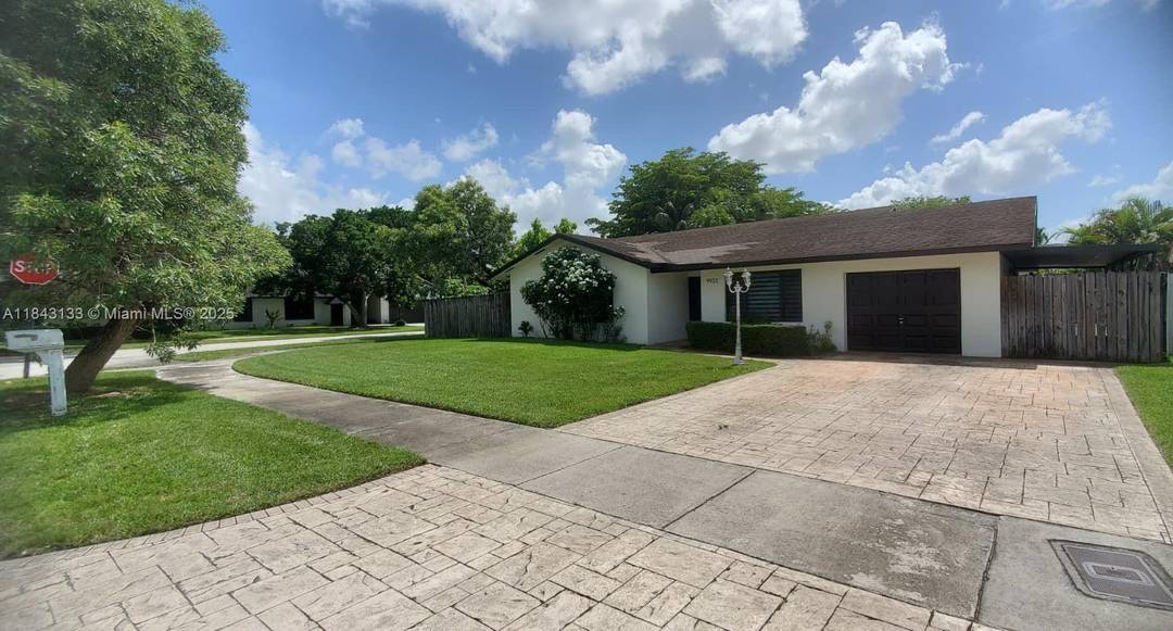 Charming corner lot home in Calusa with 3BR 2BA main house plus a 1BR 1BA converted garage suite ideal for guests or extended family.