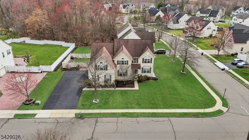 Welcome to this beautifully maintained NORTH WEST CORNER LOT home featuring soaring cathedral ceilings, skylight windows, and abundant natural sunlight throughout.