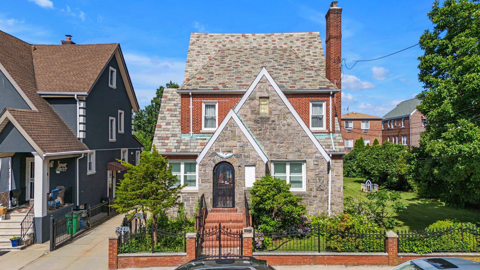 Welcome to This Stunning Tudor Style Two Family Gem Located in The Heart of Pelham Parkway nestled on an Expansive 50 x 100 Lot on a quiet, Tree Lined Street.