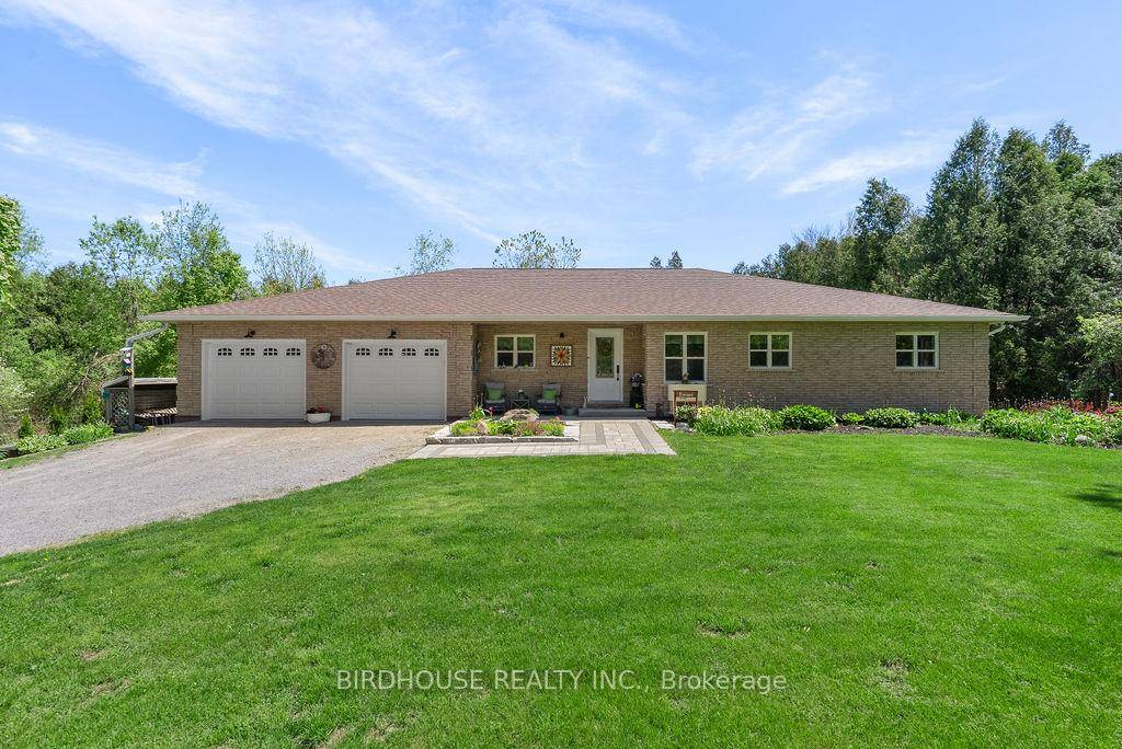 Escape to the country while staying just minutes from Lindsay in this beautifully updated 3 bedroom brick bungalow, nestled on a private and picturesque 1.