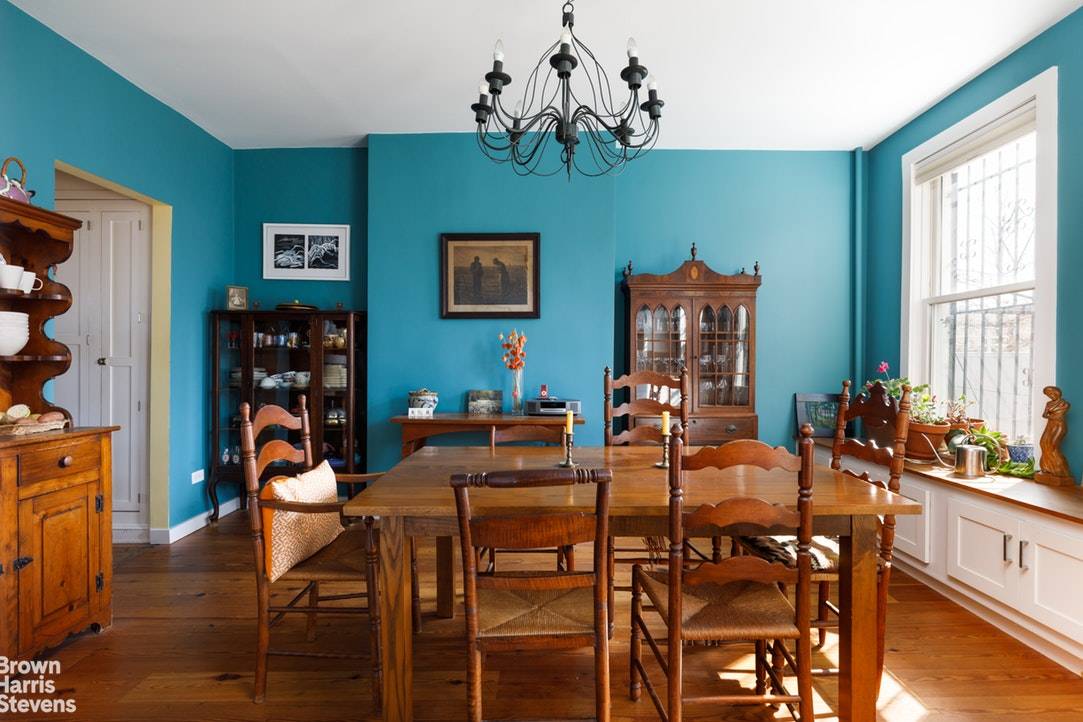 This townhouse has a distinctive peaked roof line with Gothic style decorative barge boards.