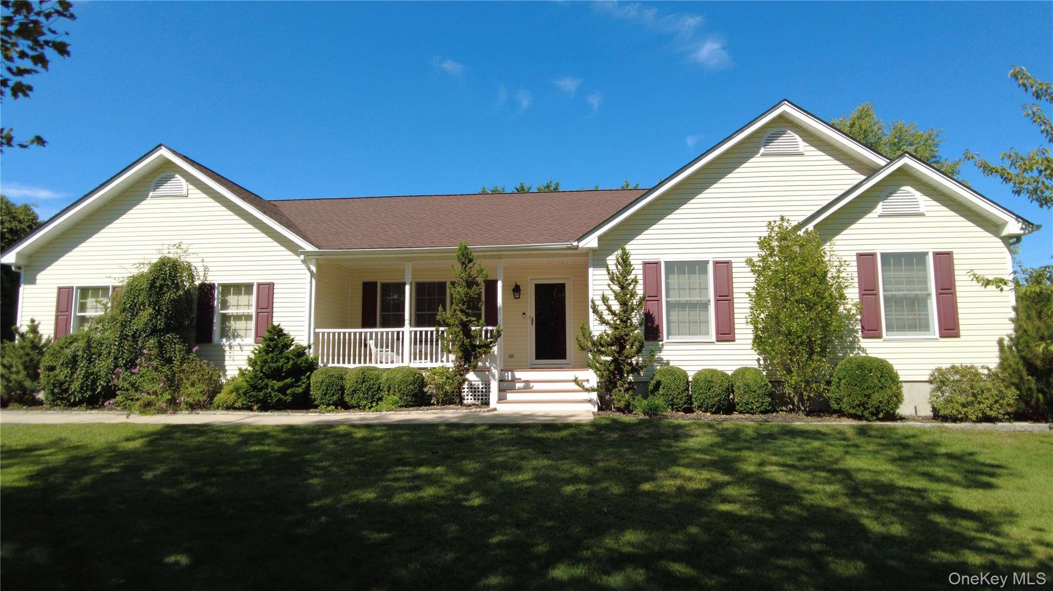 The Covered Front Porch Welcome You to this Expanded Ranch in The Desirable Neighborhood of The Manors in Beautiful Baiting Hollow.