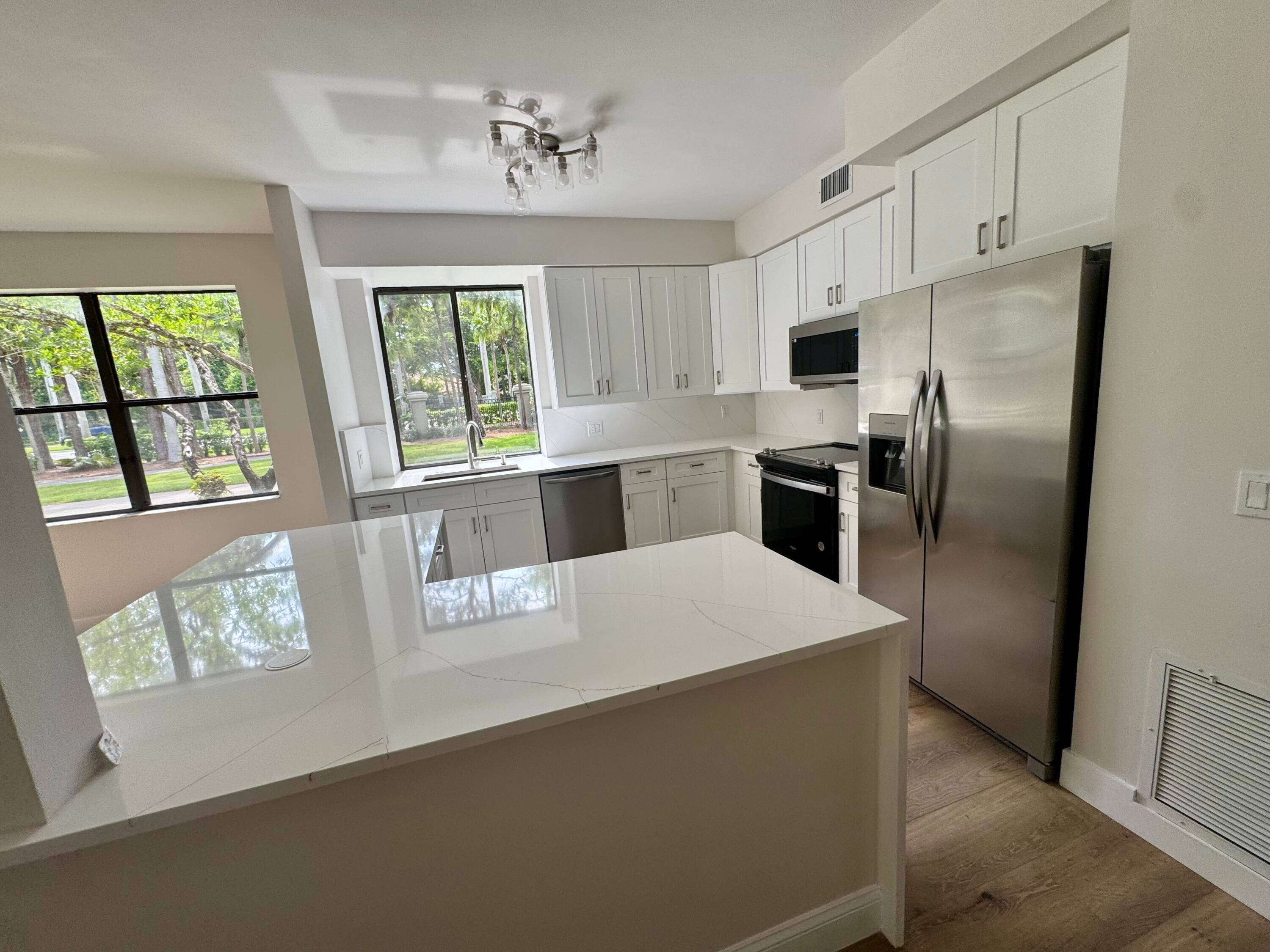 WOW ! ! Stunning Remodeled 1st floor home Steps from the Boca Raton Mall the community pool.