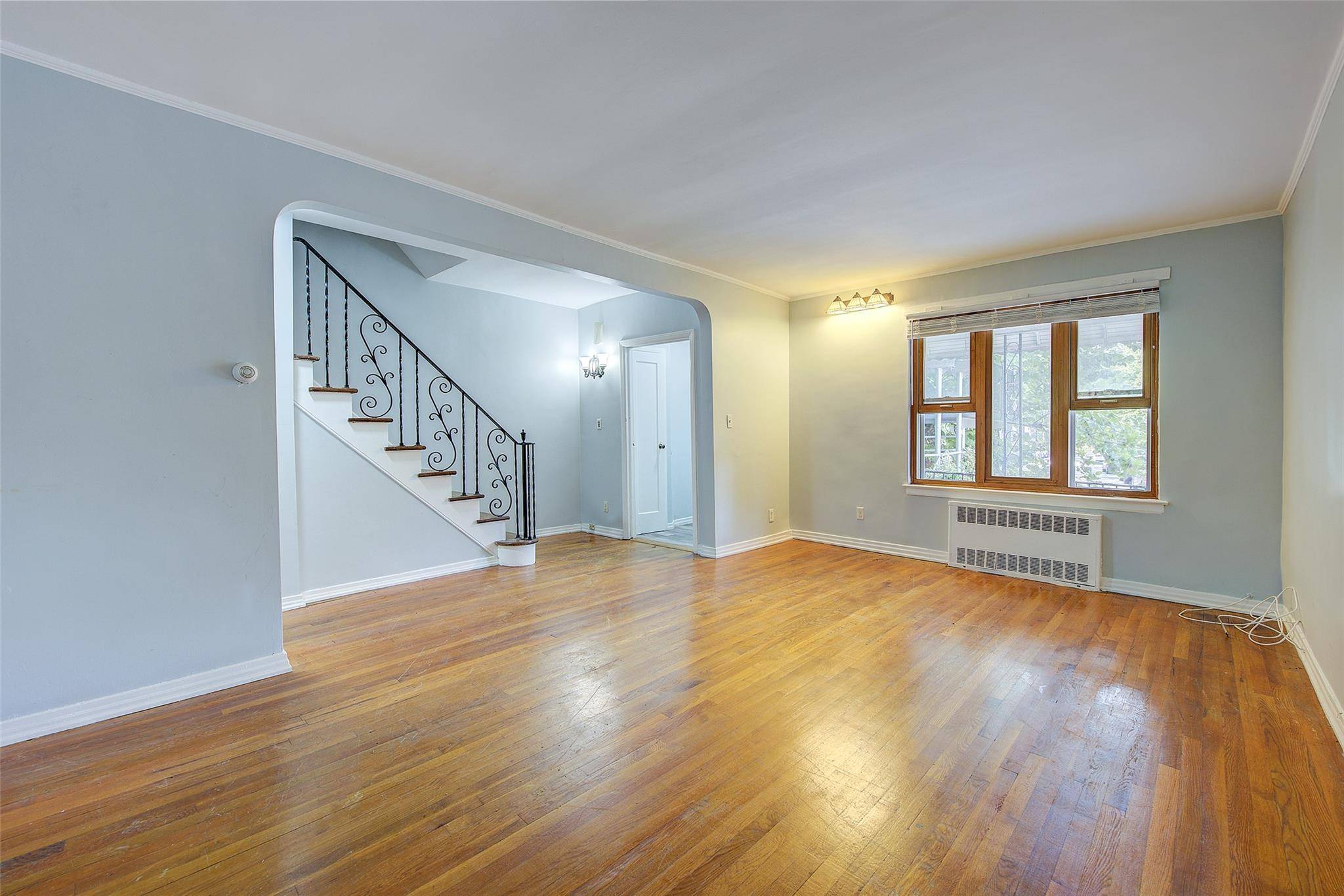 Spacious 3 bedroom house with private driveway, large front porch, above grade basement, and oversized backyard.