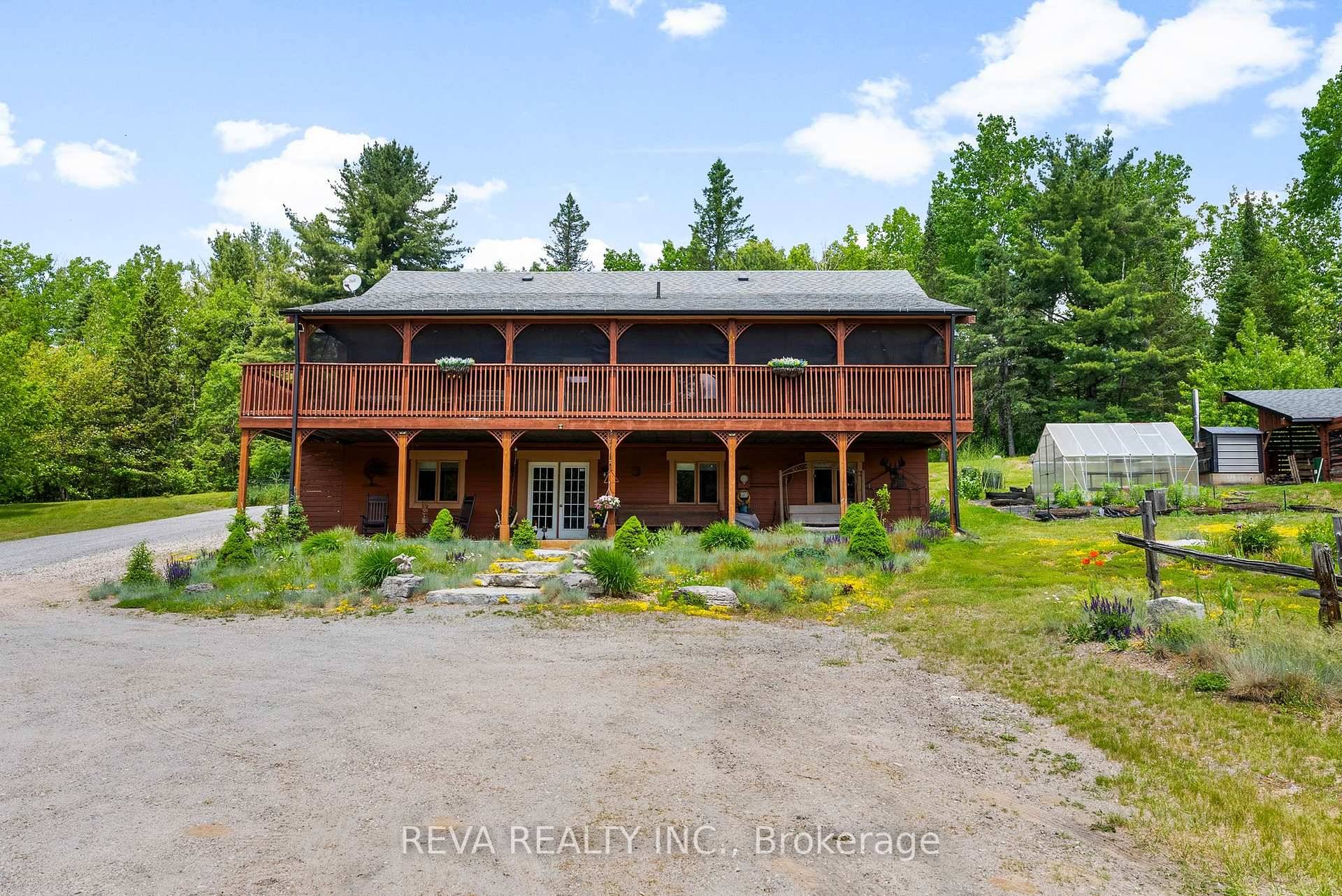 Private log home on 16 acres with creek access to Baptiste Lake offering total privacy in a beautiful park setting.