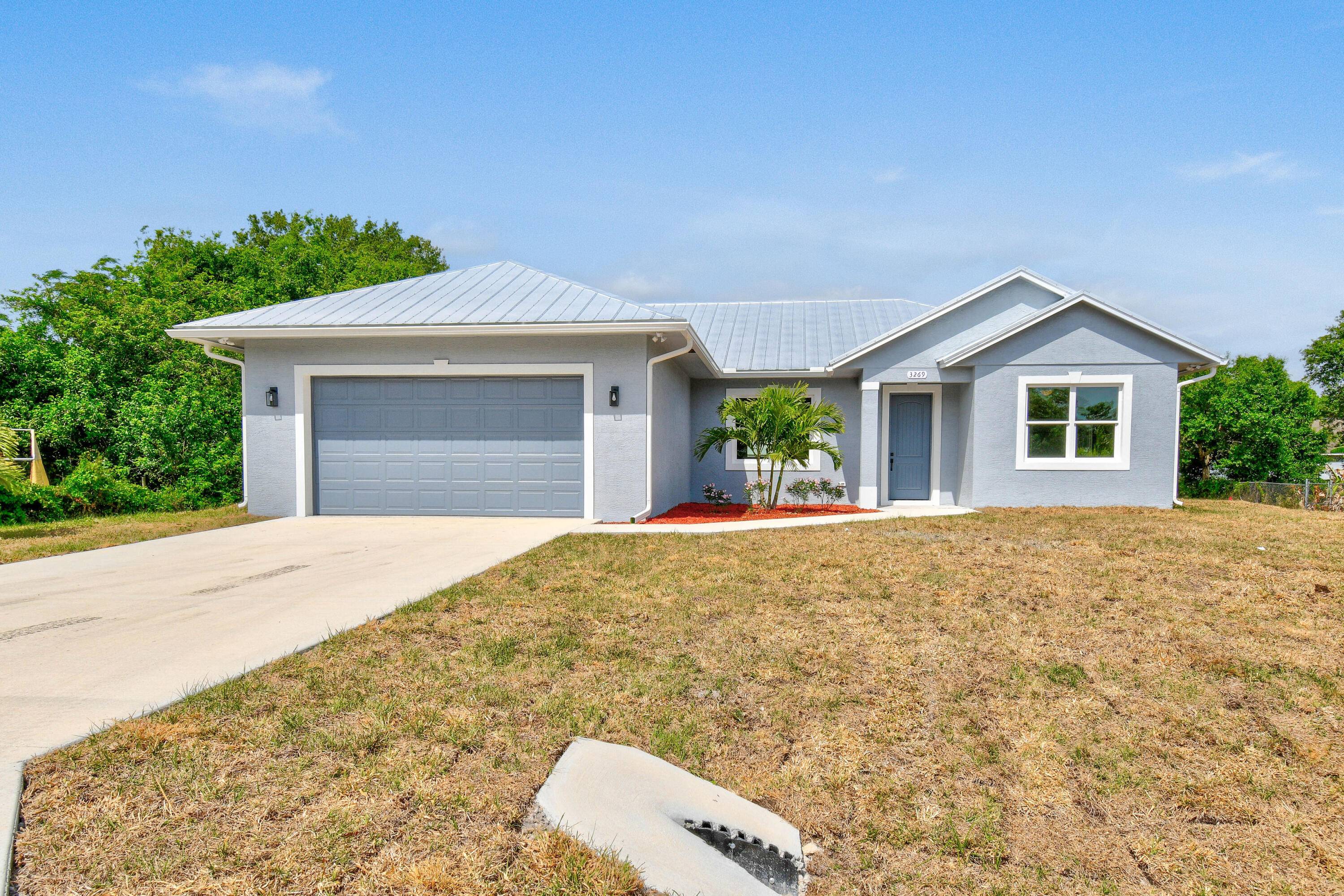 Brand New Construction on an oversized lot with a Metal roof and Impact windows.