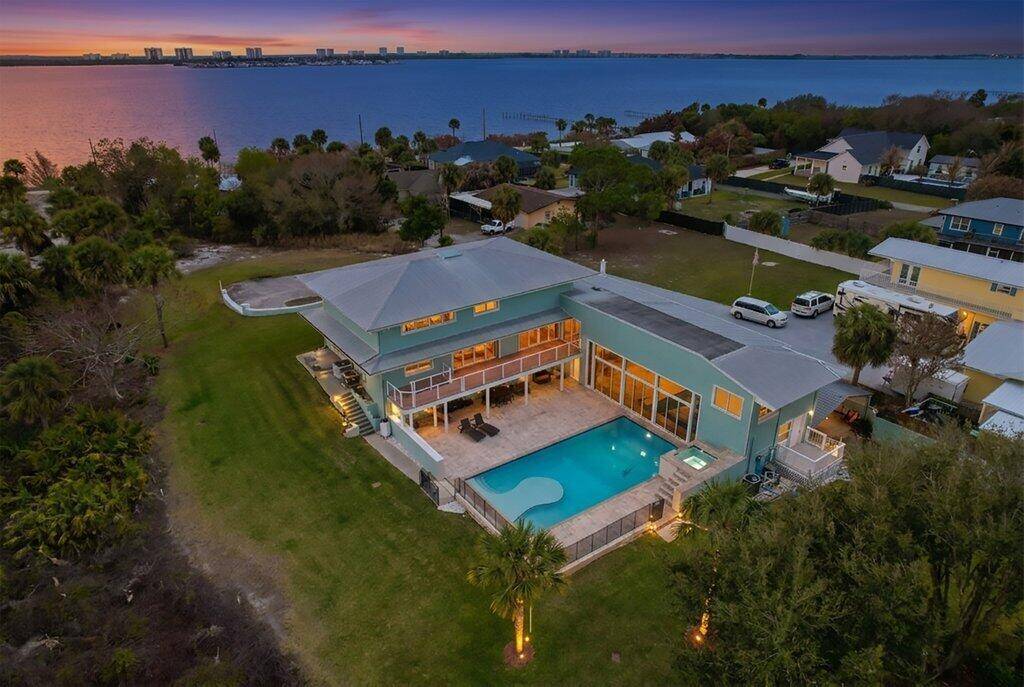 Perched high on peaceful Mockingbird Hill, this exceptional 5 bedroom, 5 full bath estate sits on 1 acre with sweeping Intracoastal water views and a versatile floor plan designed for ...