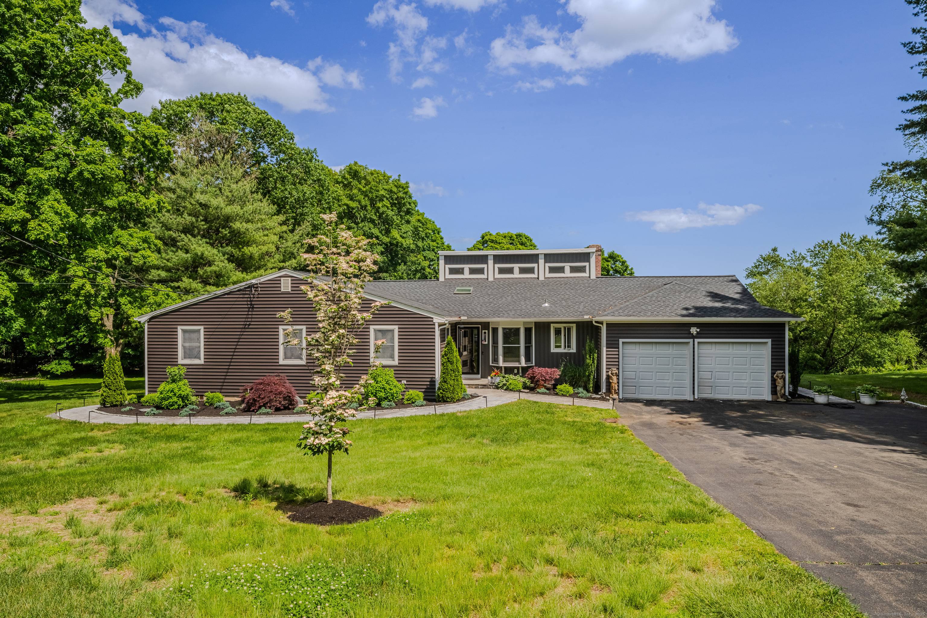 Beautifully updated Contemporary Ranch offering a total of 4319 SF ft of light filled living space on just under an acre in a quiet, established neighborhood.