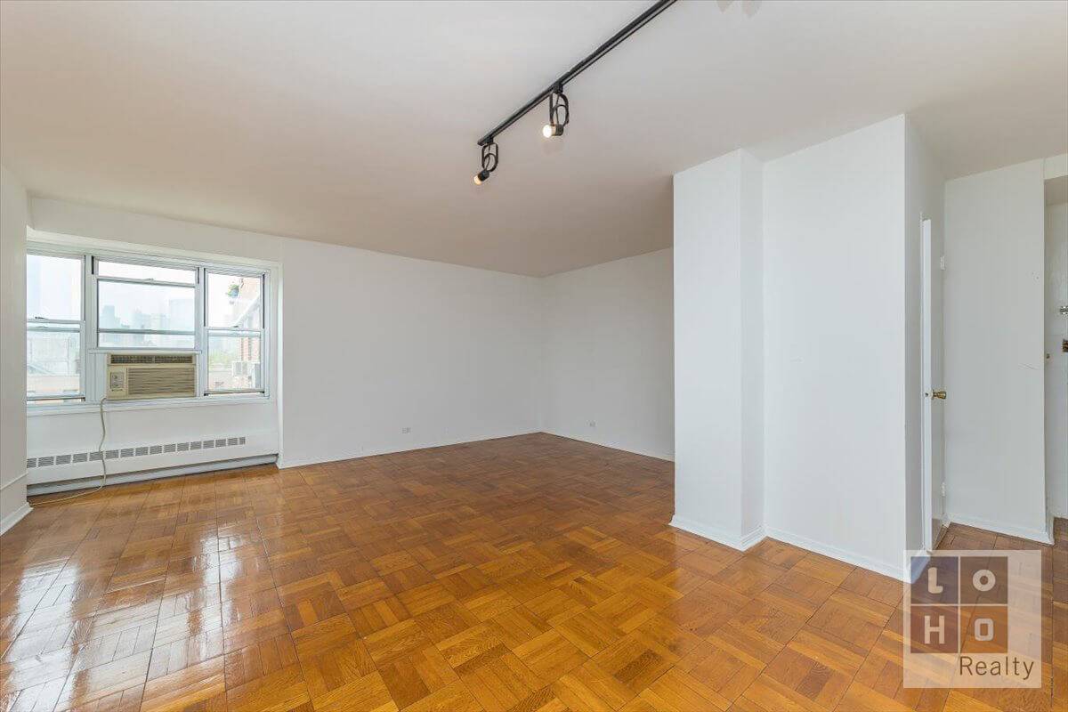 Sunny 1 bedroom apartment featuring views of the downtown city skyline, including the Freedom Tower, from every room !