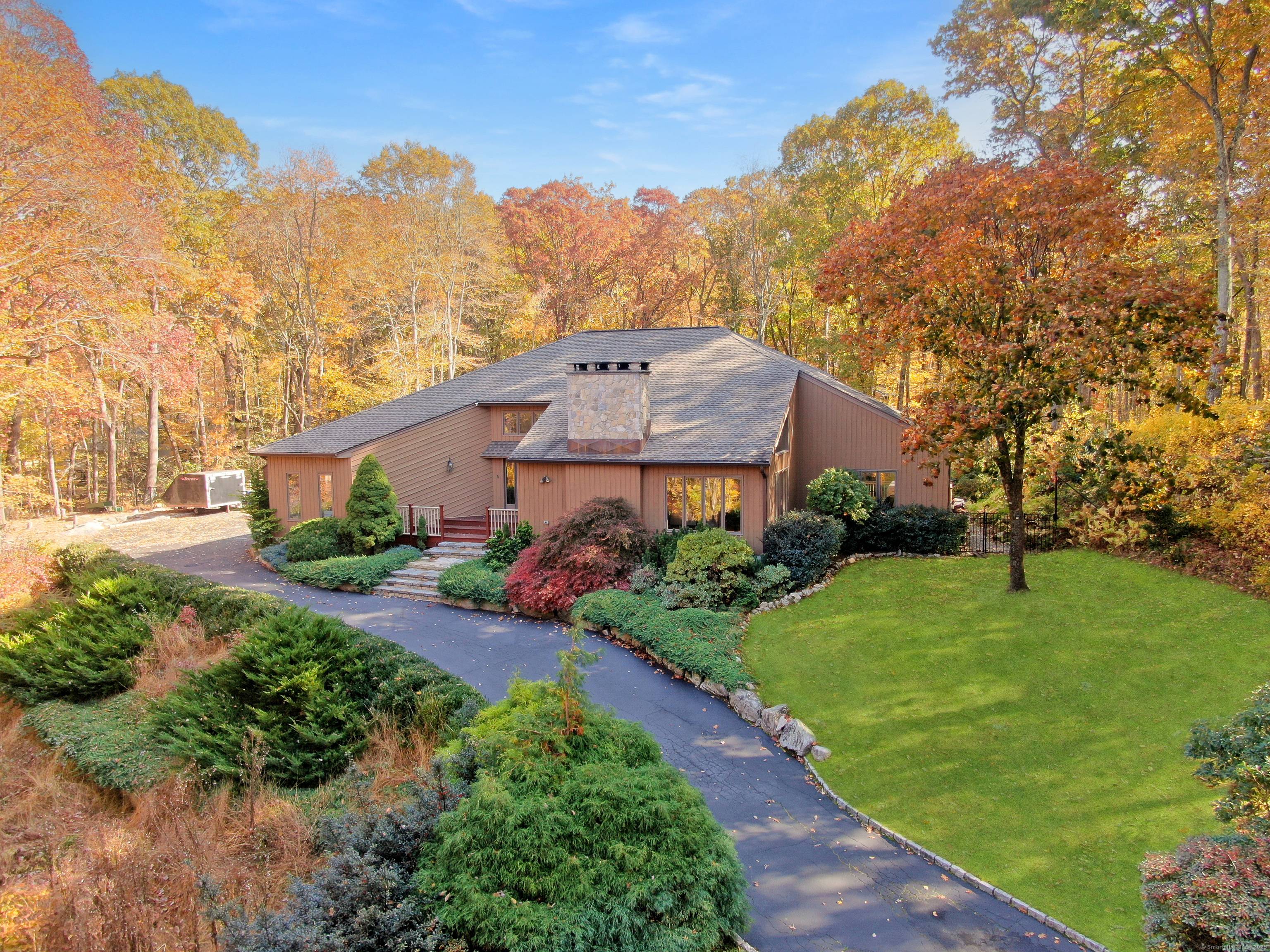 Natural light, soaring ceilings, and a dramatic stone fireplace set the tone for this spacious contemporary on one of the best lots in a quiet cul de sac.