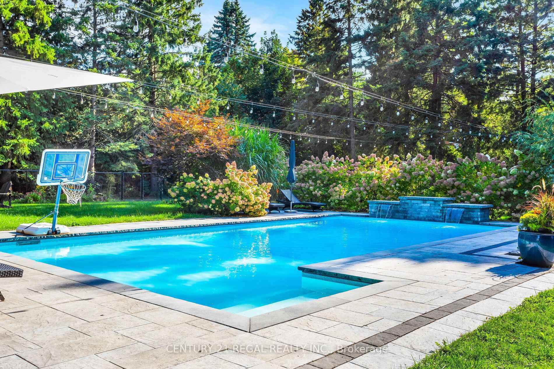 Charming tudor style 4 bedroom home on nearly 1 Acre with a gorgeous saltwater pool.