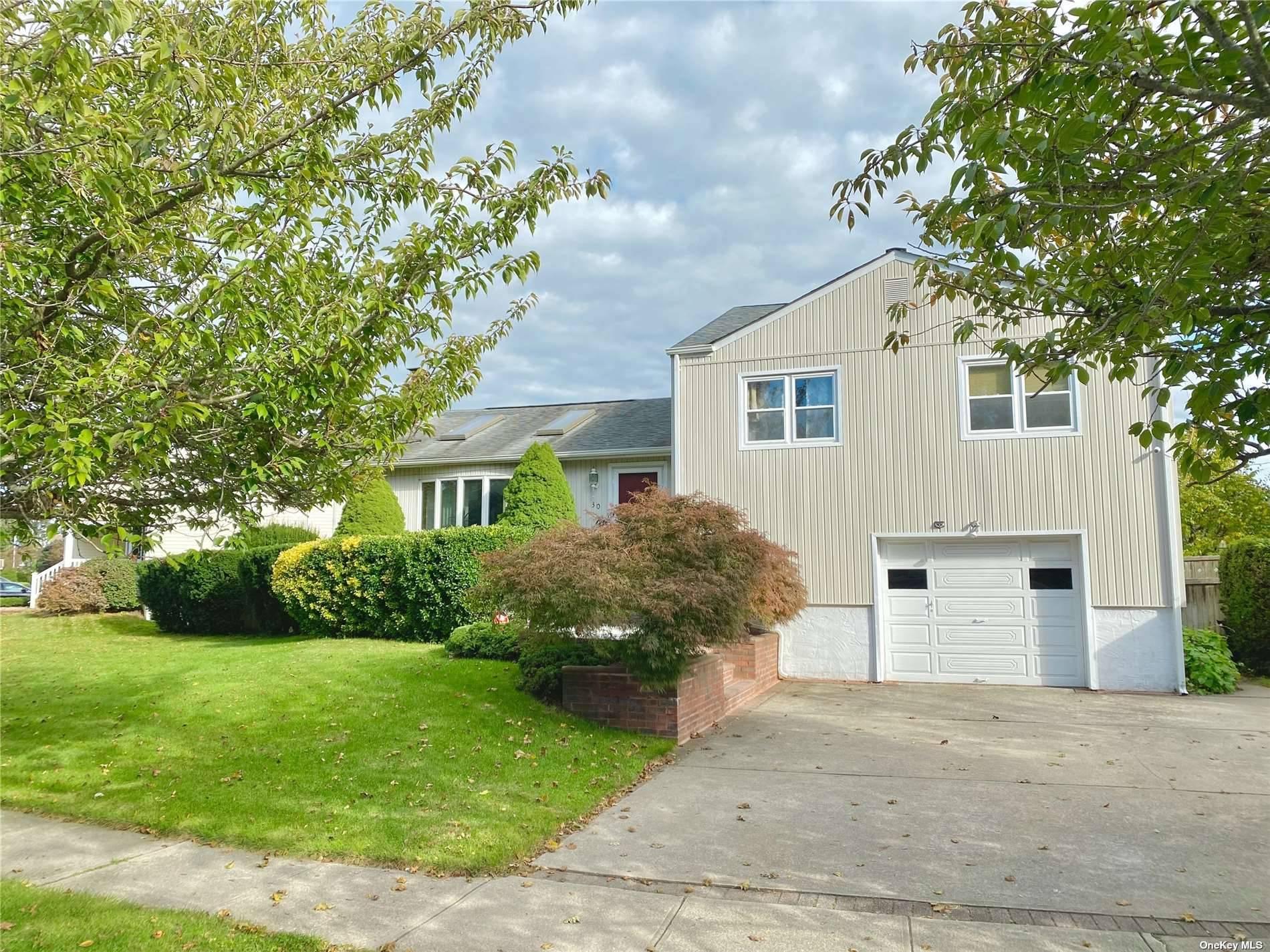 Charming Split Level Single Family Residence on Lovely Tree Lined Street.