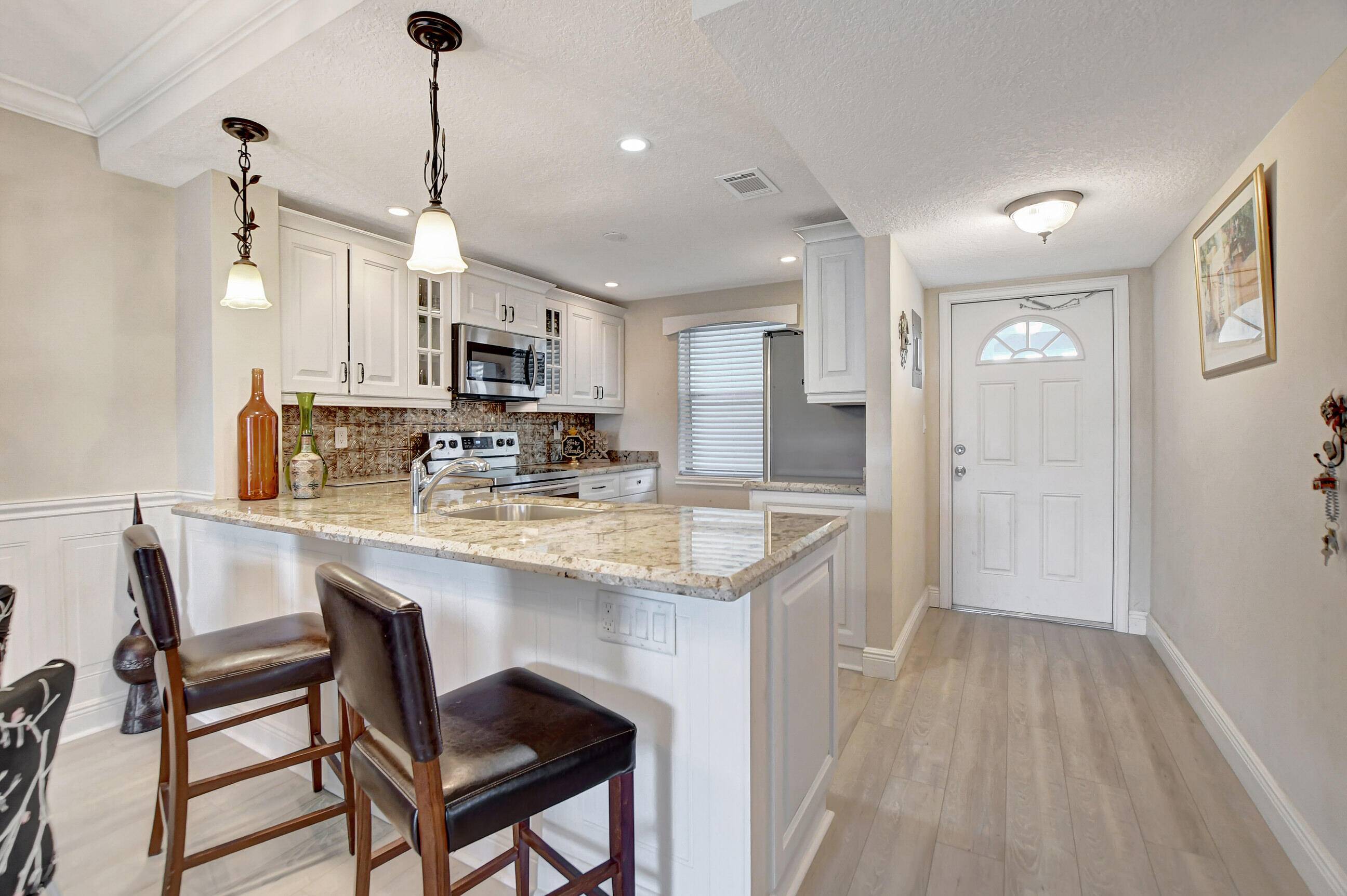 Magnificently updated and maintained 2 bedroom, 2 bath corner unit overlooking the lake and garden beyond.