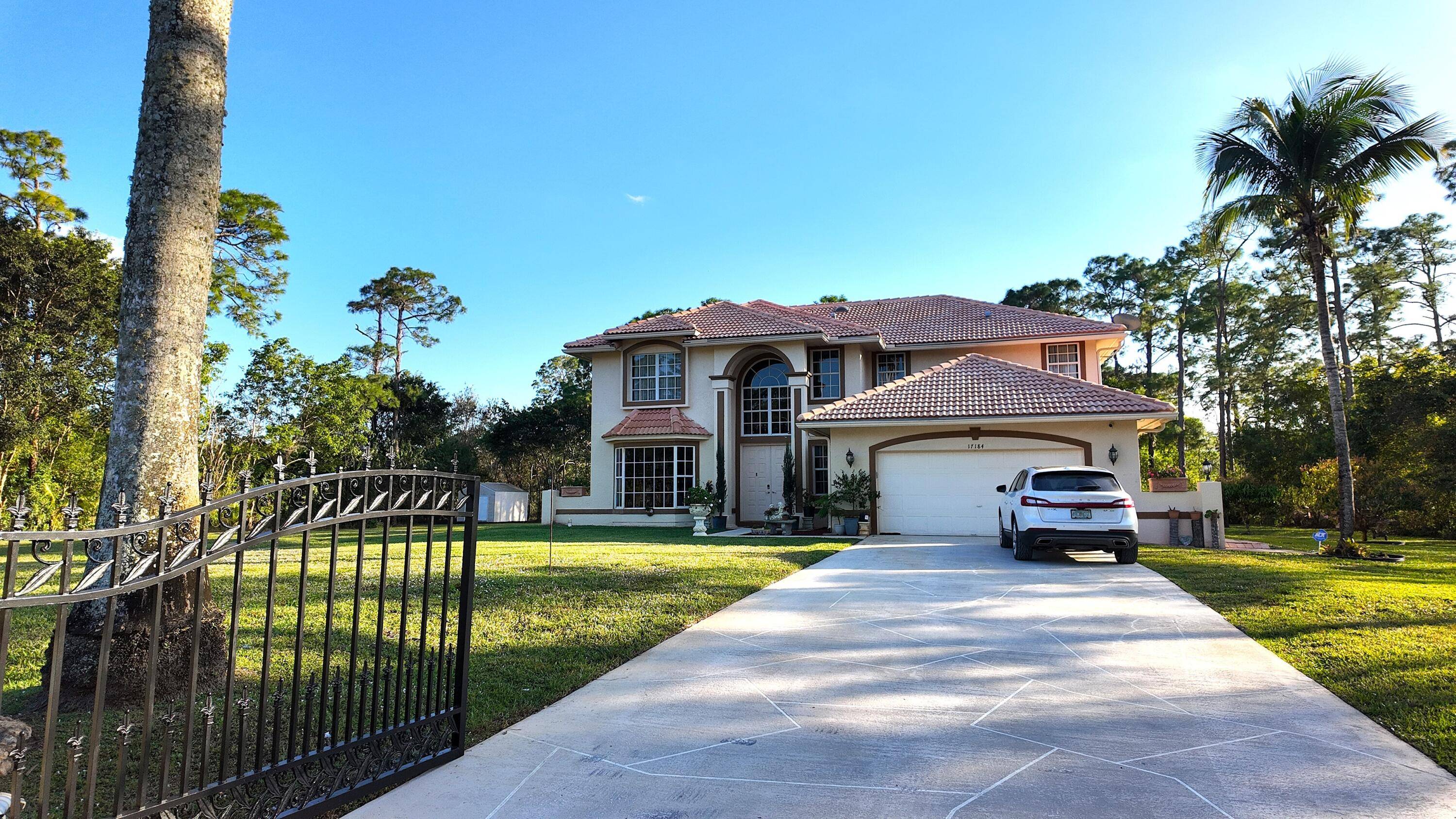 This private, gated estate in Loxahatchee offers over an acre of land, complete with fruit trees, a 35x16 pool with spa, and plenty of space to enjoy Florida living.