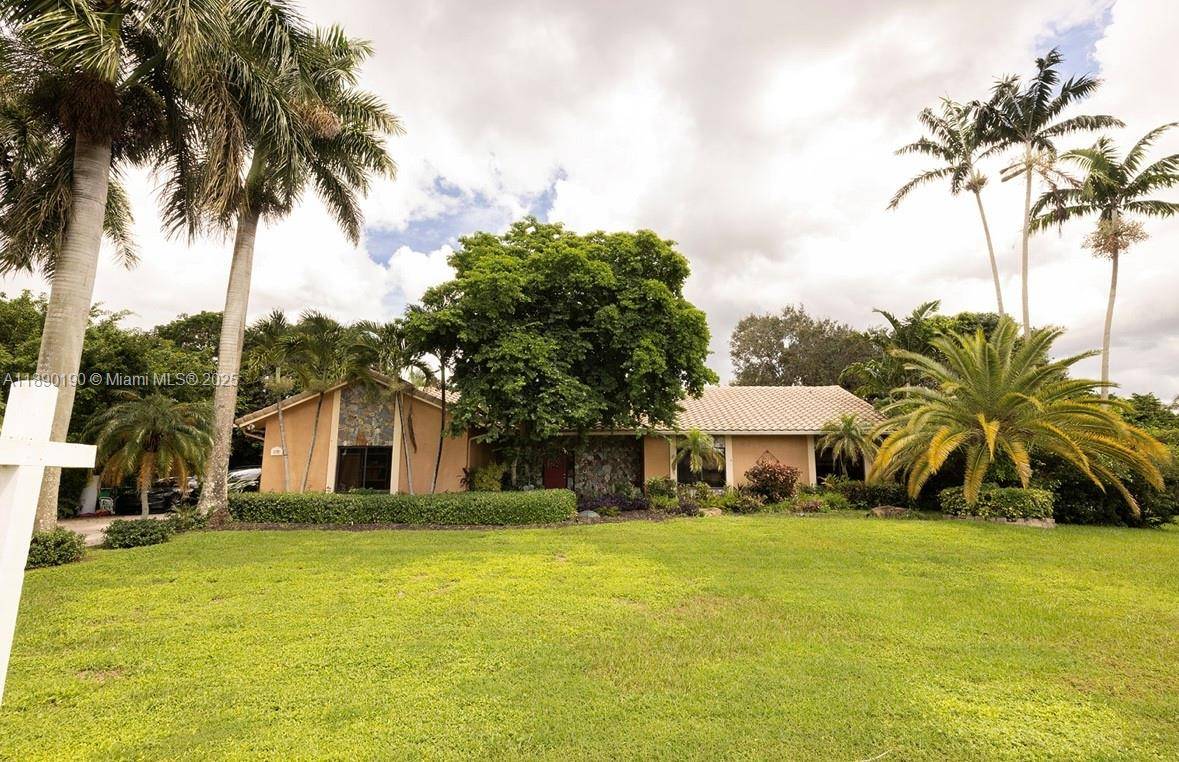 DISCOVER YOUR OWN PRIVATE RESORT IN THE HEART OF DAVIE W THIS EXQUISITE LUXURY ESTATE ON A BUILDERS ACRE.