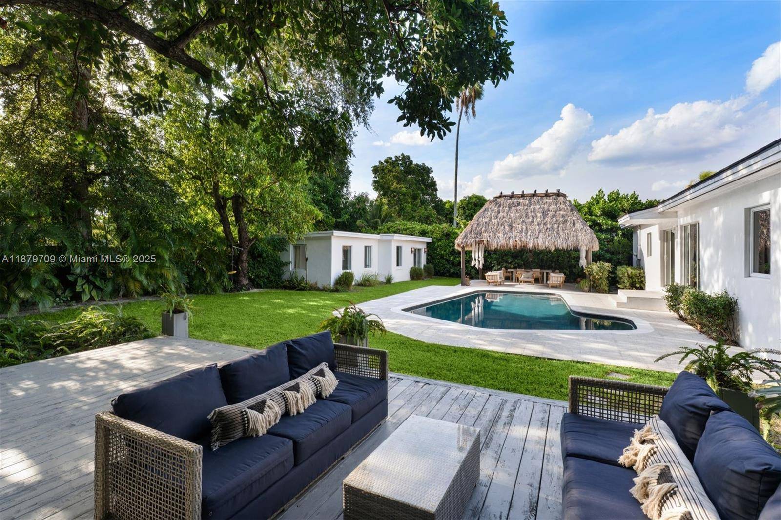 Turn key gated Mimo estate on an expansive 14, 878 SF lot offering exceptional privacy.