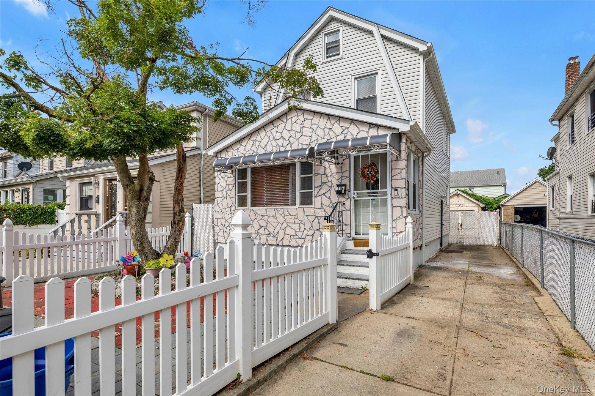 This beautifully updated detached two family home located on a quiet, tree lined block in Springfield Gardens.