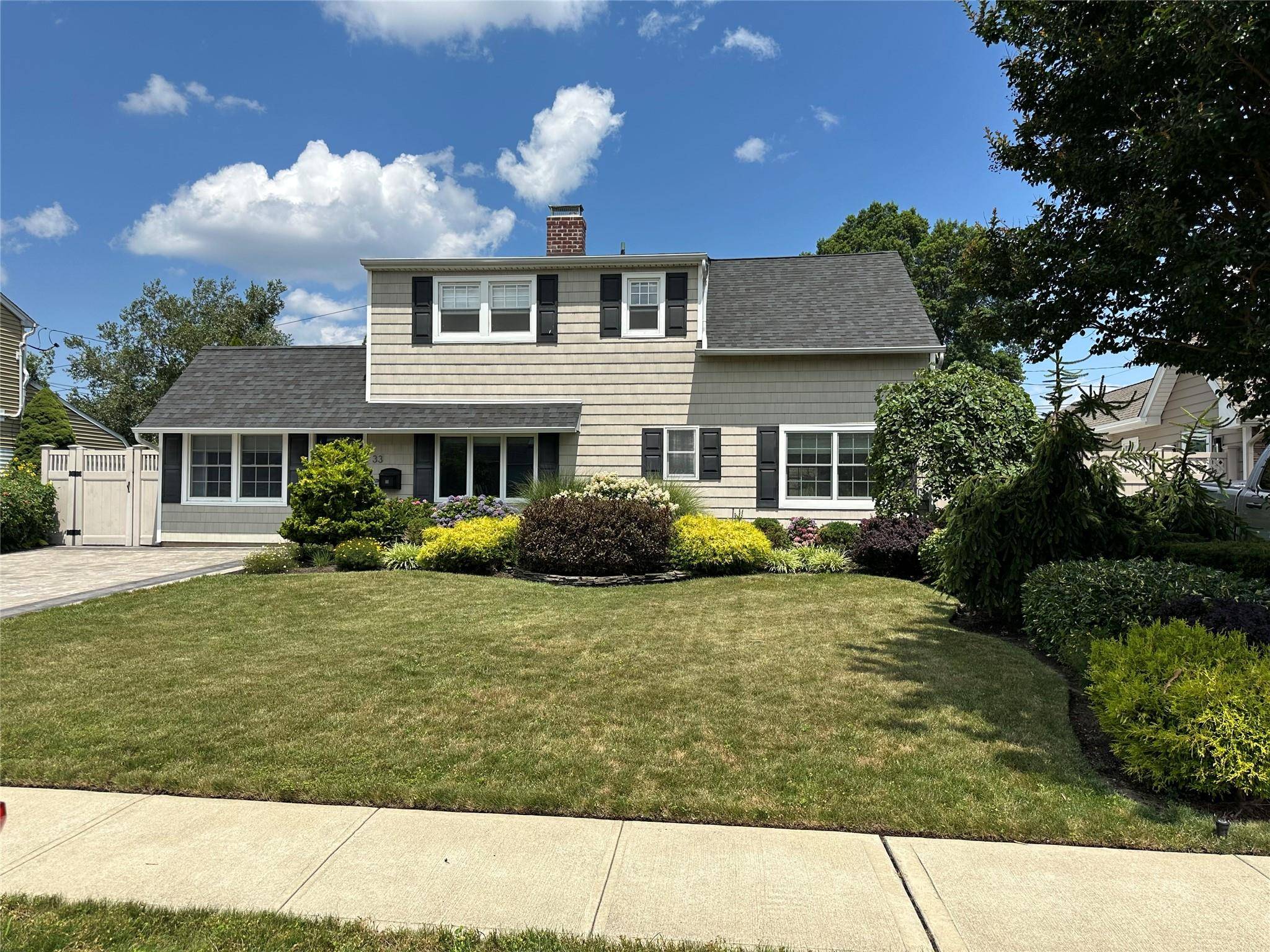 this home is beautiful and move in ready great open floor plan and wonderful landscaped great storage for a Levittown house