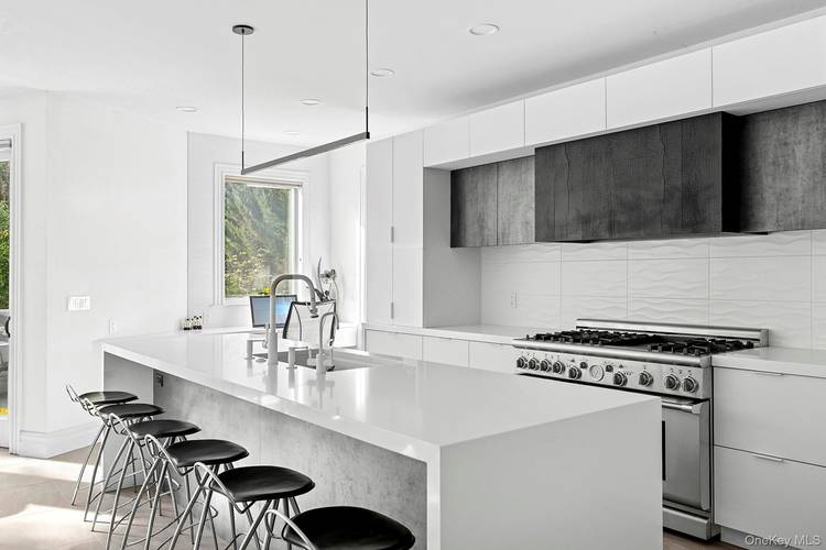 Experience luxurious living across three levels in this beautifully renovated residence set on nearly two private acres in coveted West Hills.